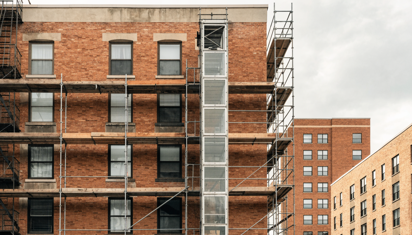 Scaffolding against the brick facade of an older Toronto mid-rise apartment building during major exterior renovation