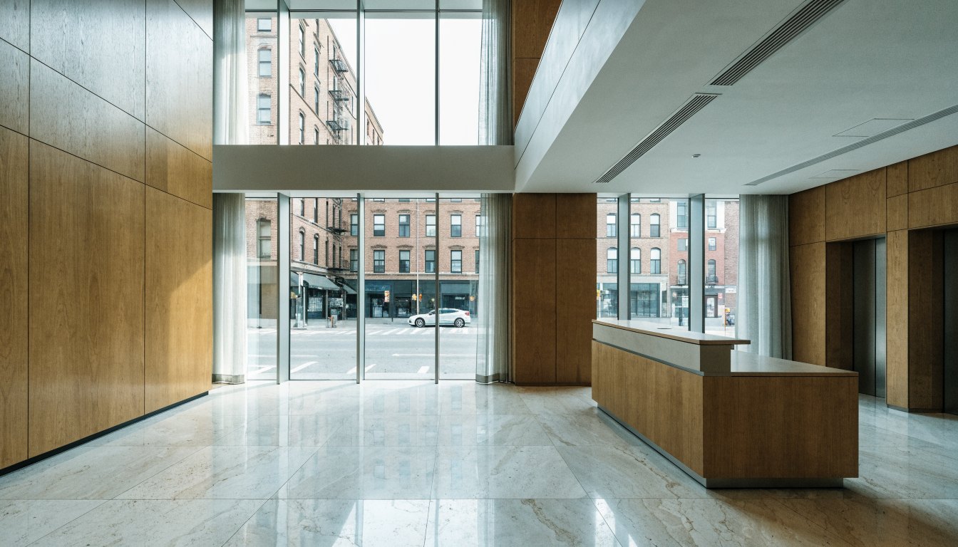 Contemporary condominium lobby interior with a concierge desk