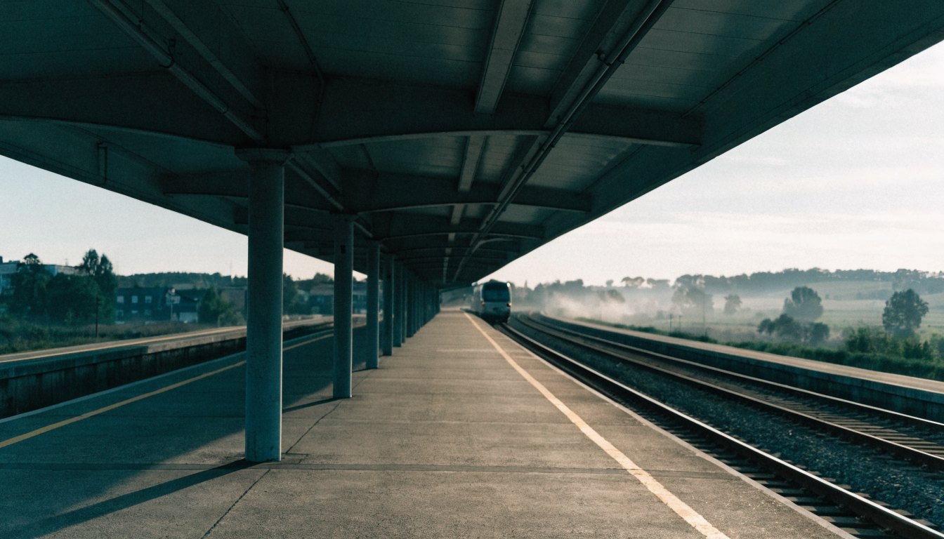 An empty commuter rail platform with a train approaching, illustrating GO Transit access
