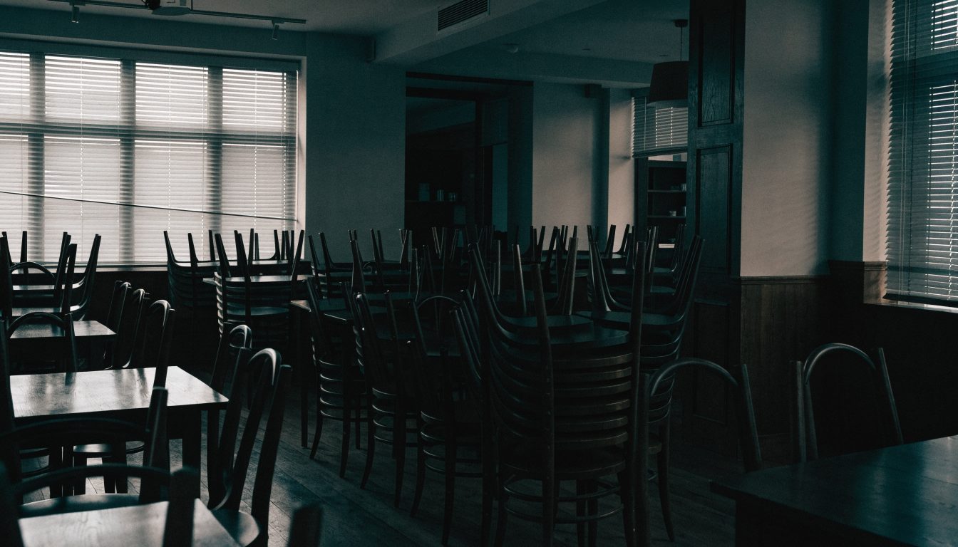 Restaurant dining room with chairs stacked on tables (illustrative)