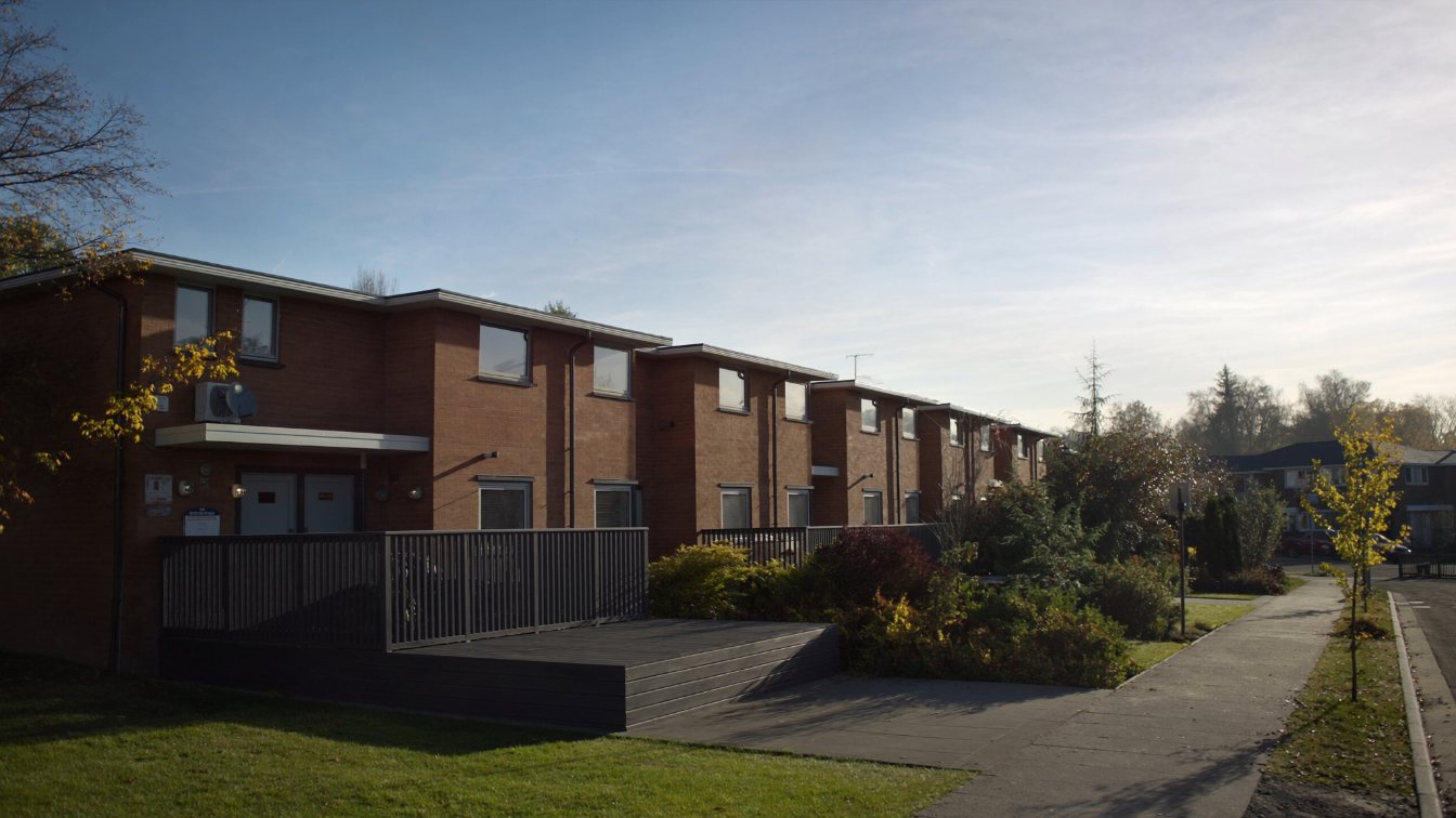 Row of one-storey brick bungalows with small gardens in an Ontario adult community (illustrative)