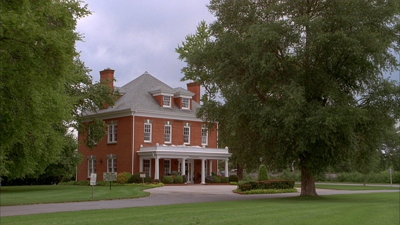 Traditional brick funeral home with a covered entrance and landscaped front lawn in an Ontario town (illustrative)
