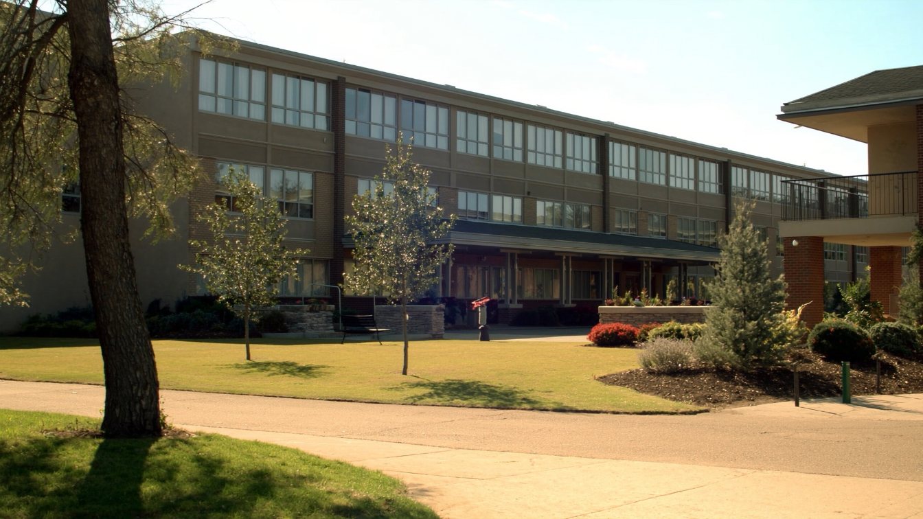 Low-rise seniors residence with a landscaped courtyard, benches and large windows in a GTA suburb (illustrative)