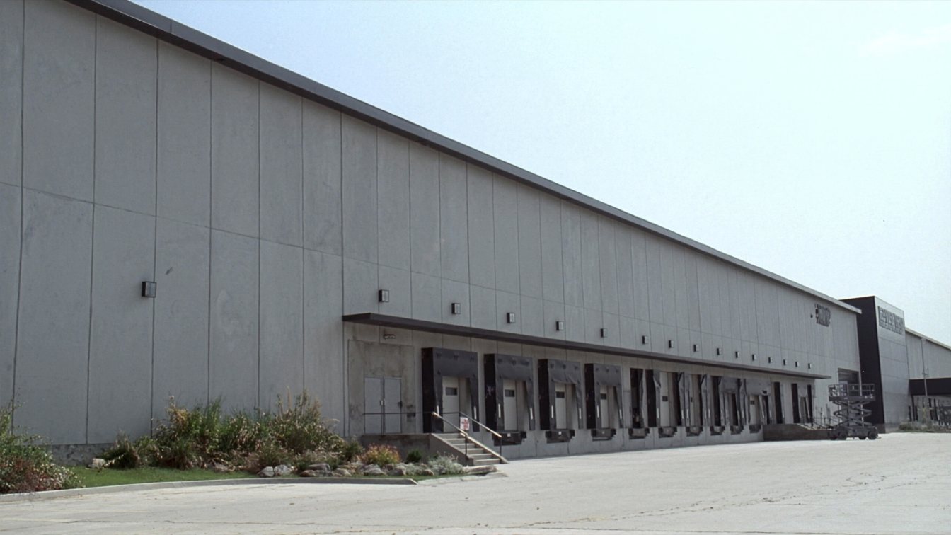 Tilt-up concrete warehouse with dock-level loading doors and a truck court in a GTA industrial park (illustrative)