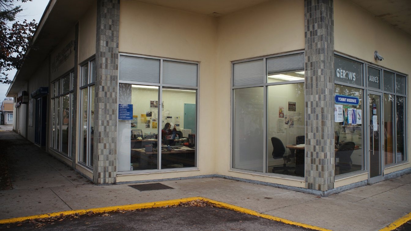 Small street-front insurance brokerage office with glass frontage in a GTA plaza (illustrative)