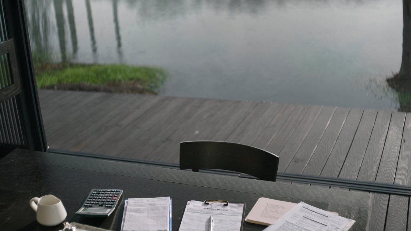 A wall calendar beside a set of keys on a plain desk in soft daylight (illustrative)