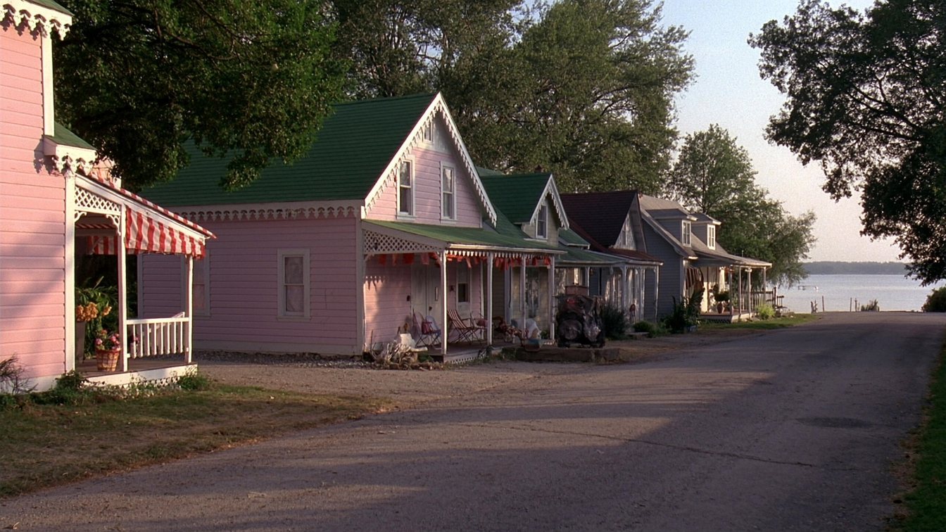 Colourfully painted Victorian cottages on a narrow lane near a Lake Ontario beach in Grimsby (illustrative)