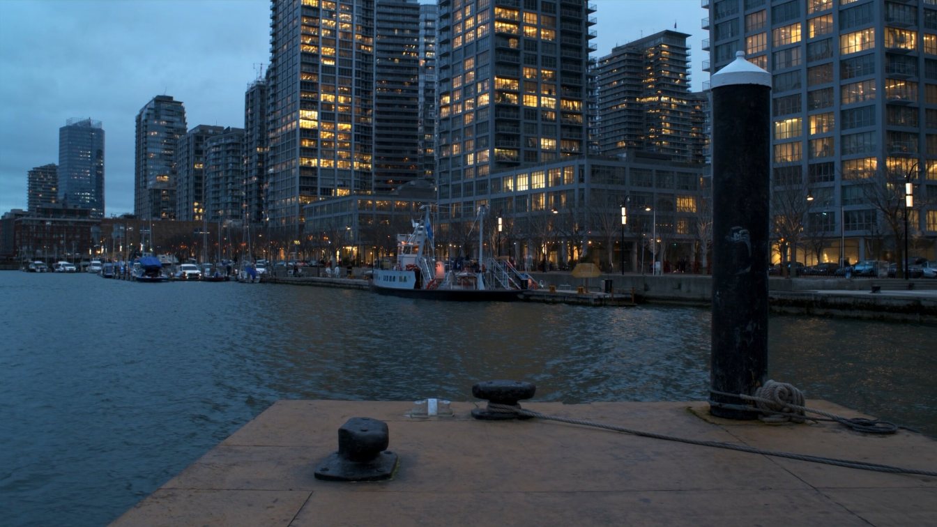 Downtown Toronto condominium towers along the Harbourfront with the lake and a ferry in the foreground (illustrative)