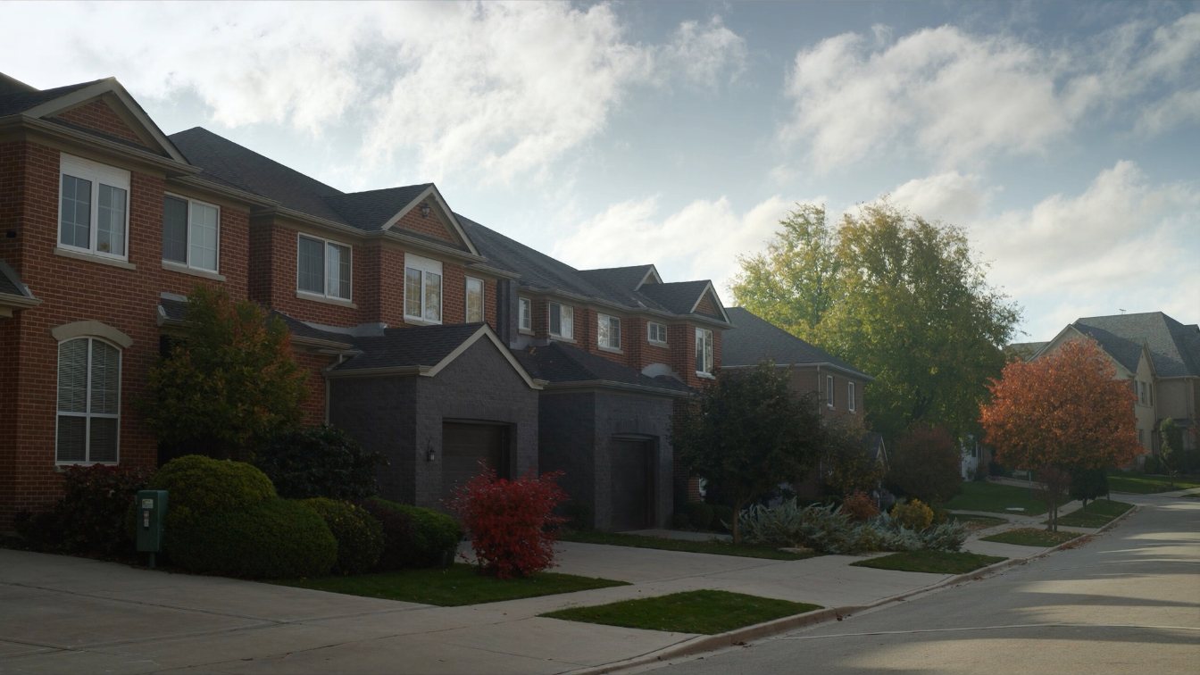 Tree-lined suburban street of two-storey detached brick houses with double garages in Markham (illustrative)