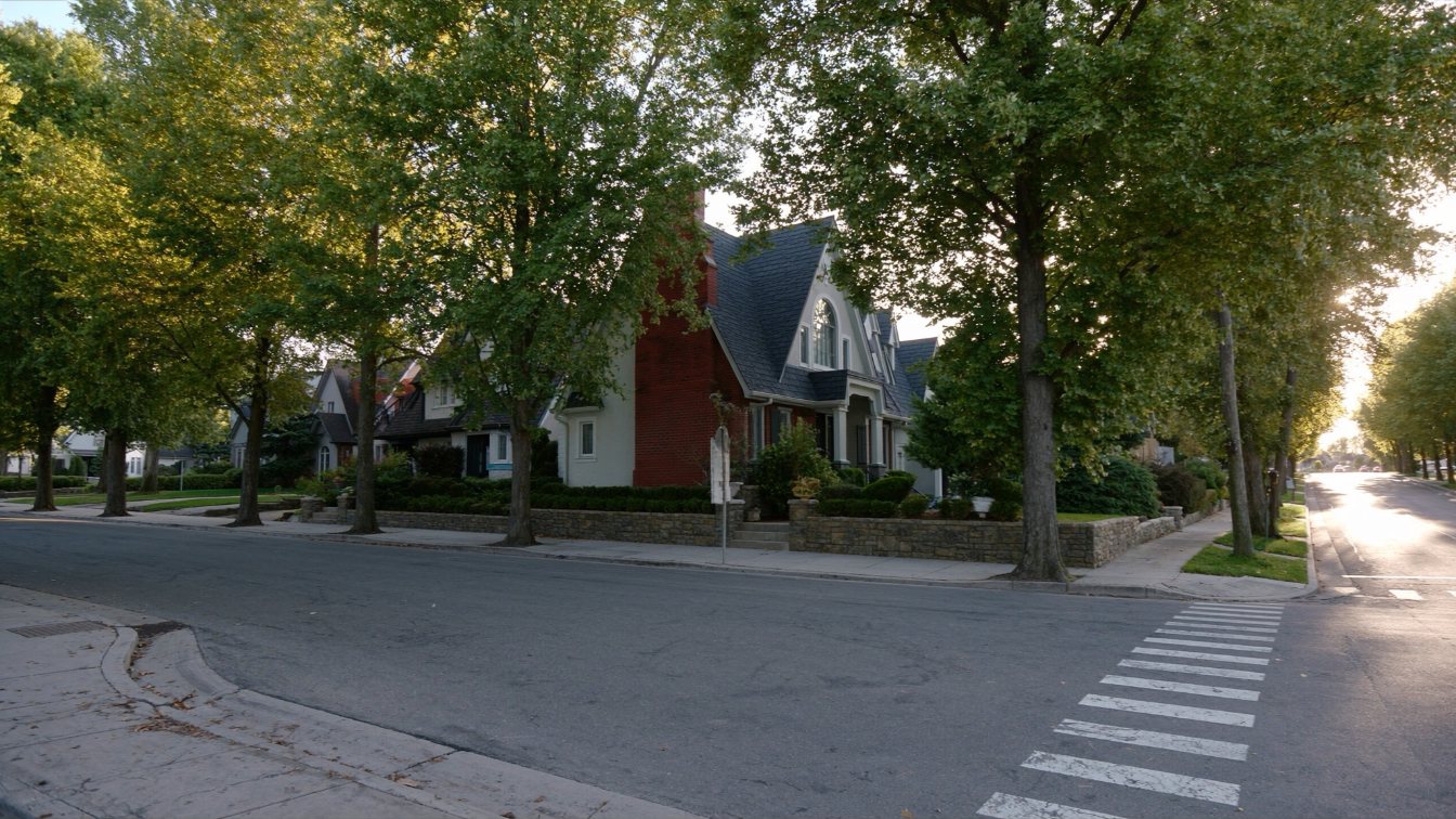 Tree-lined street of detached brick homes in south Oakville near the lake in late summer (illustrative)