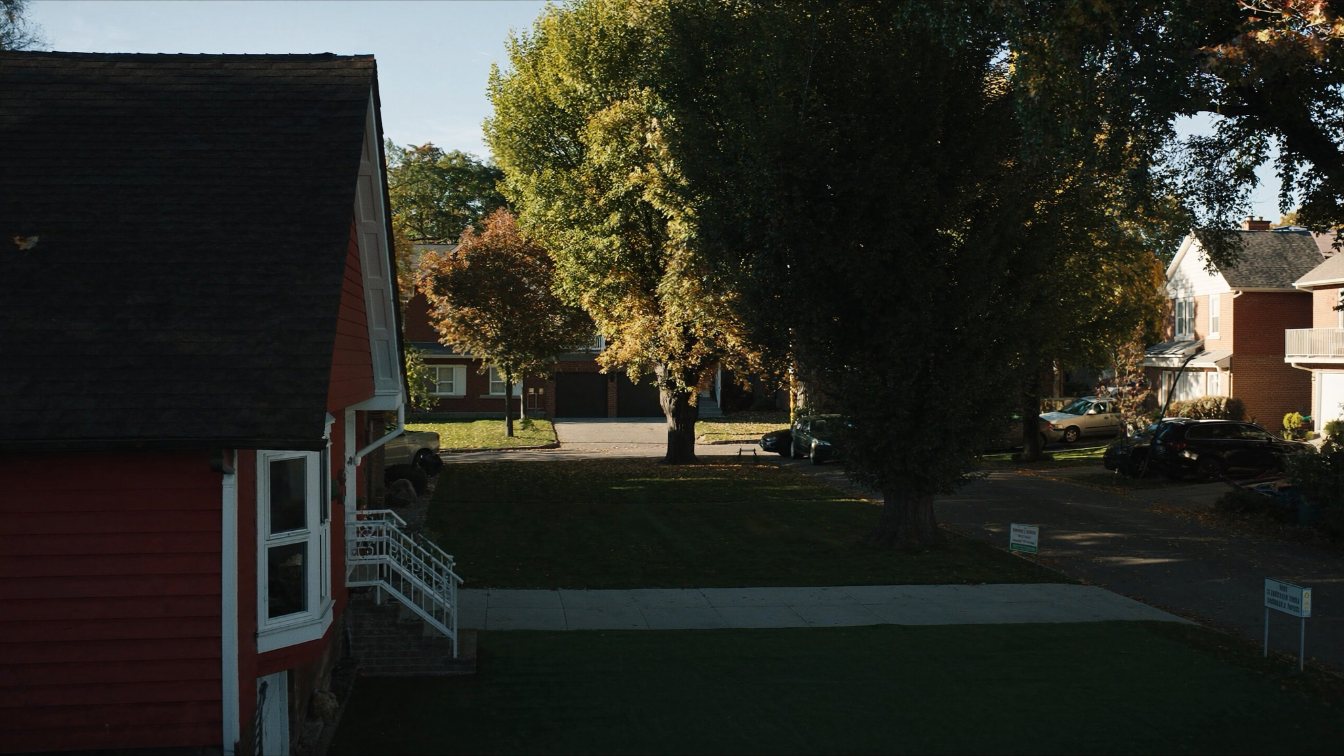 Scarborough residential street of brick bungalows and two-storey detached houses with driveways and mature maples (illustrative)