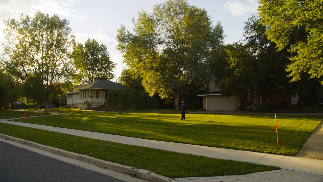 A cleared vacant residential lot with survey stakes on a quiet suburban street in the Greater Toronto Area (illustrative)