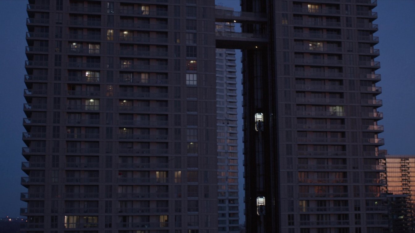 Condominium towers in Toronto at dusk with lit windows at different floor levels (illustrative)