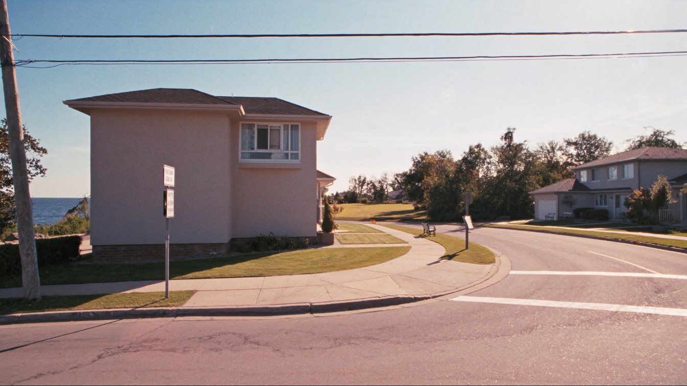 Detached houses on a quiet Long Branch street set against the wall of high-rise condominium towers at Humber Bay Shores (illustrative)