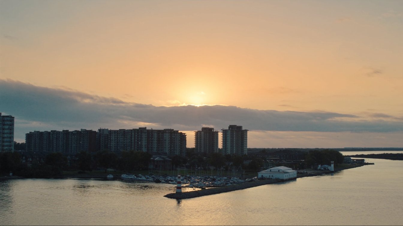 Lake Ontario shoreline at Port Credit, Mississauga, with a marina and low-rise condominiums (illustrative)