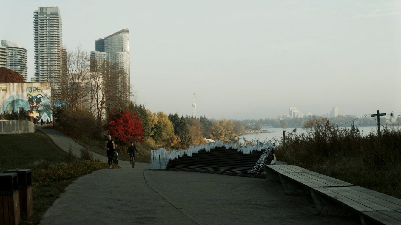Lakefront walking path at Humber Bay in Etobicoke with benches and condo towers in the distance in autumn (illustrative)