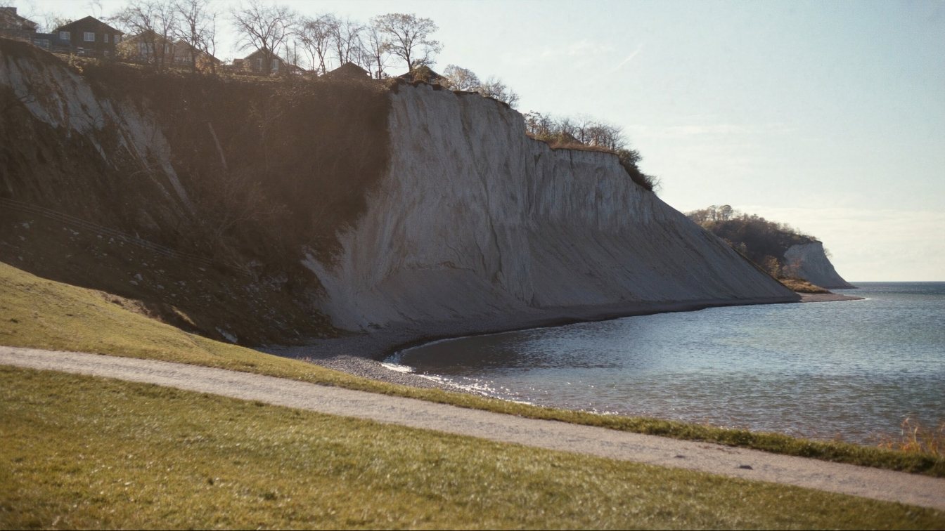 Scarborough Bluffs cliffs above Lake Ontario with a shoreline path on a clear autumn day (illustrative)