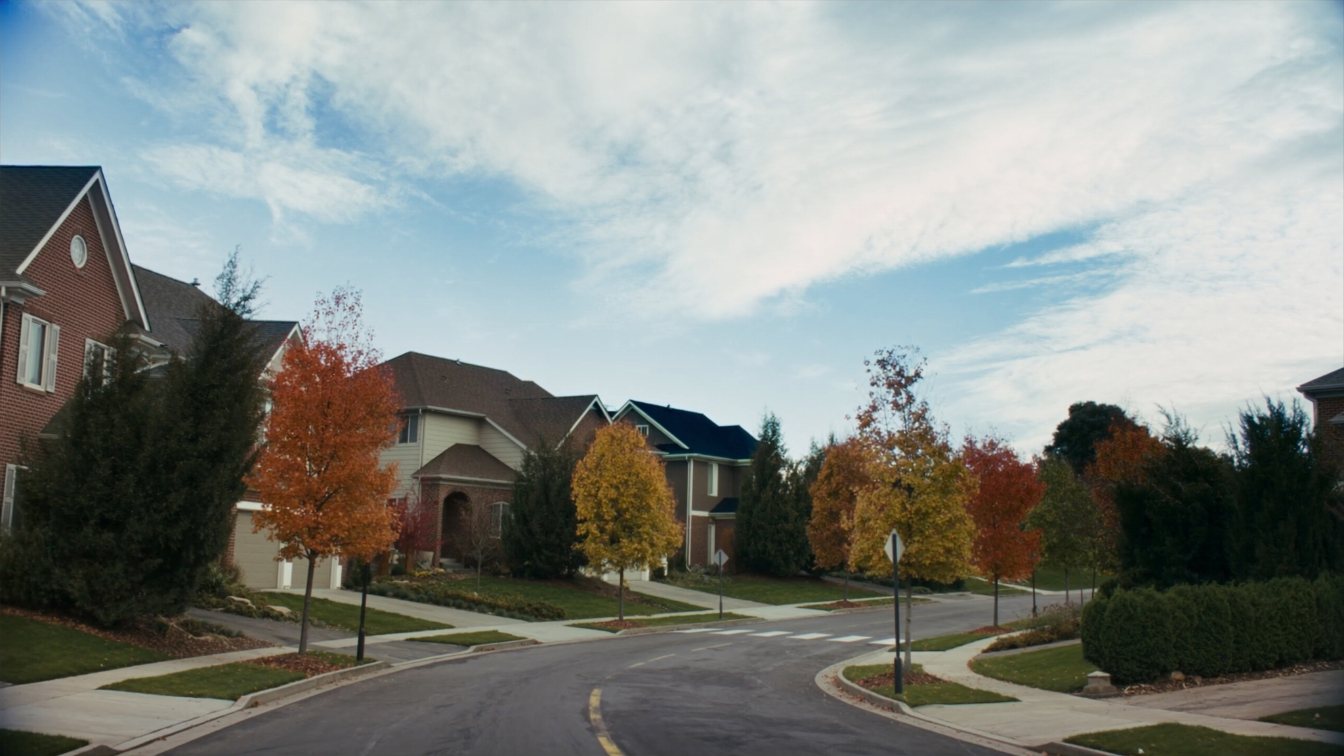 Tree-lined suburban street with brick houses in York Region in early autumn (illustrative)
