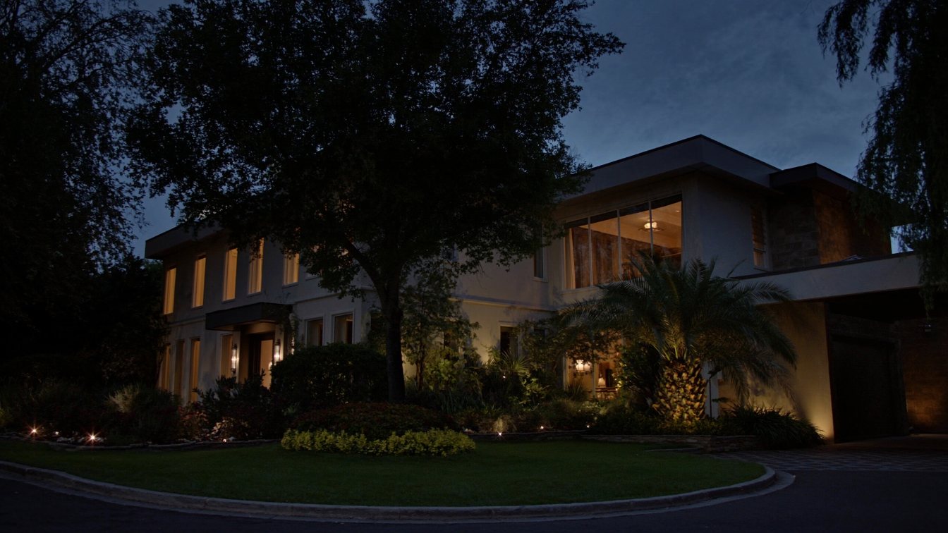A large elegant Toronto house presented for sale with warm interior lights in early evening (illustrative)