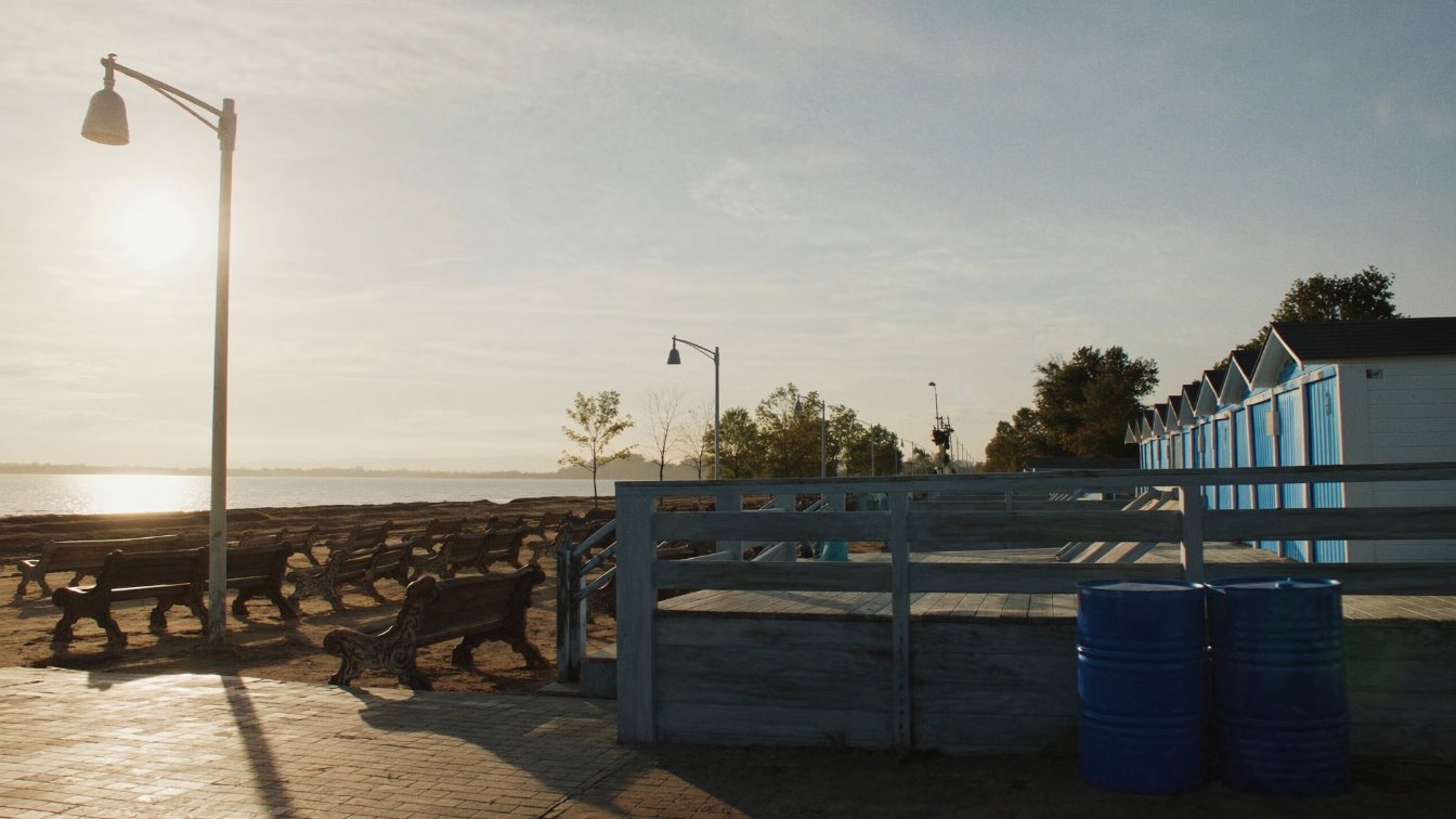 The boardwalk and sand at Kew Beach in The Beaches beside a 1920s brick detached house on a Birch Cliff street (illustrative)