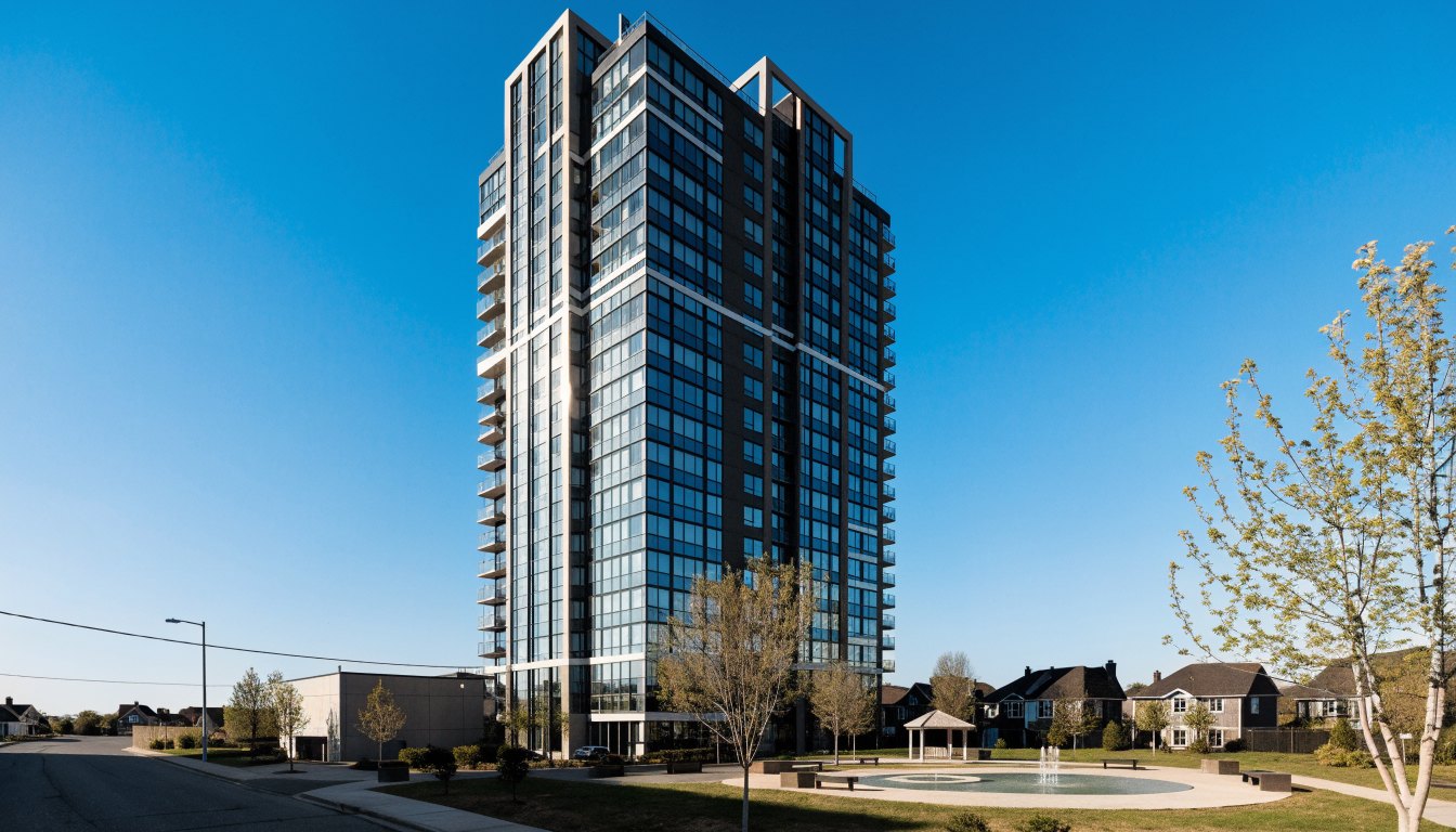 Twenty-storey glass condominium tower above a landscaped courtyard with a playground