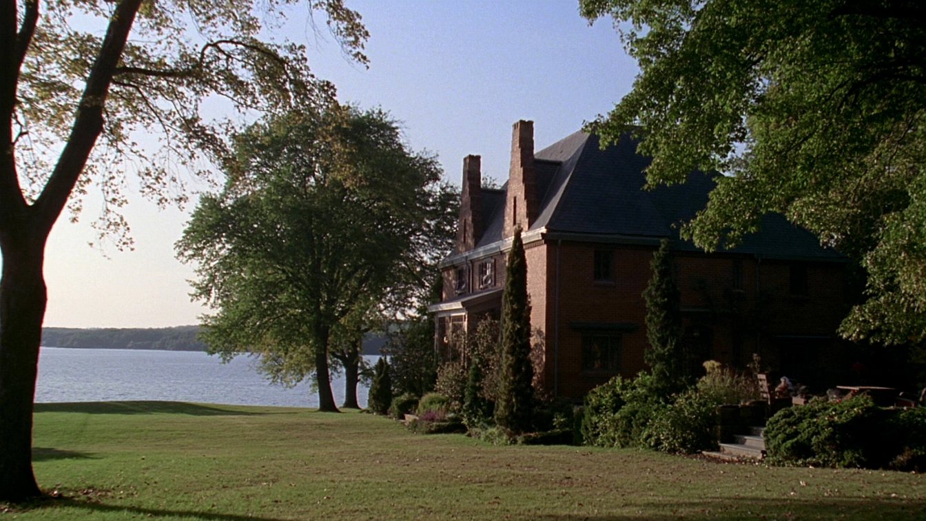 Large detached house with a wide lawn running toward a treed Lake Ontario shoreline in Halton (illustrative)