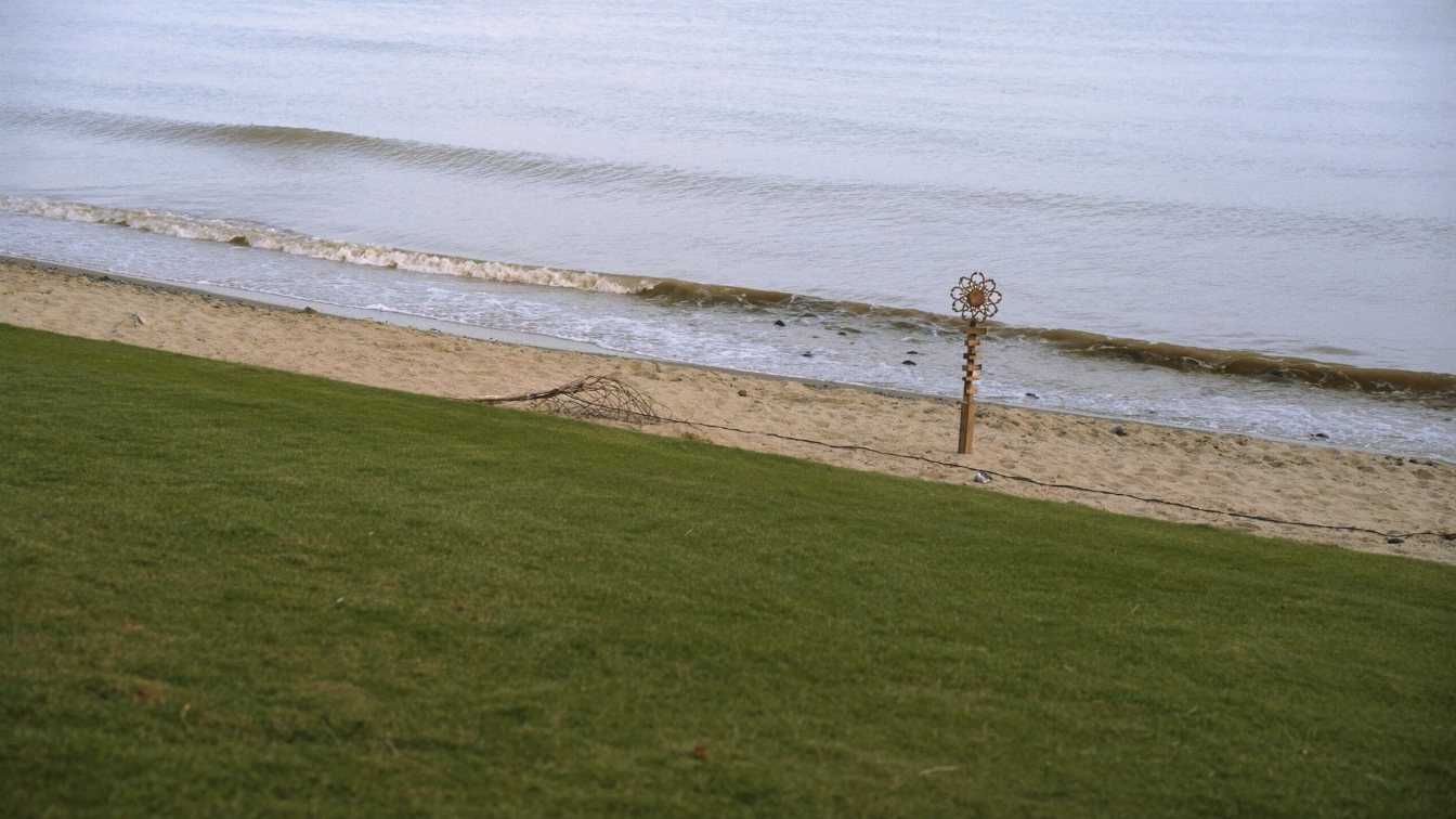 Sandy Lake Ontario beach below a row of waterfront homes with a surveyor's marker in the foreground (illustrative)