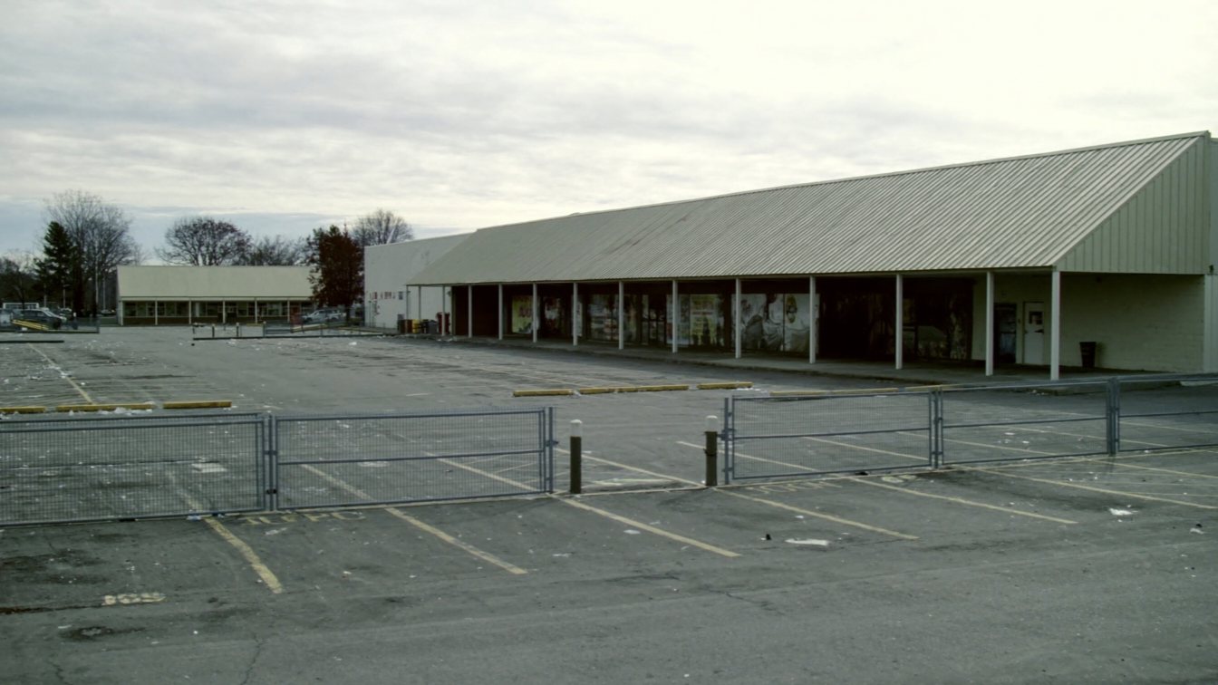 Older suburban shopping mall with surface parking (illustrative)