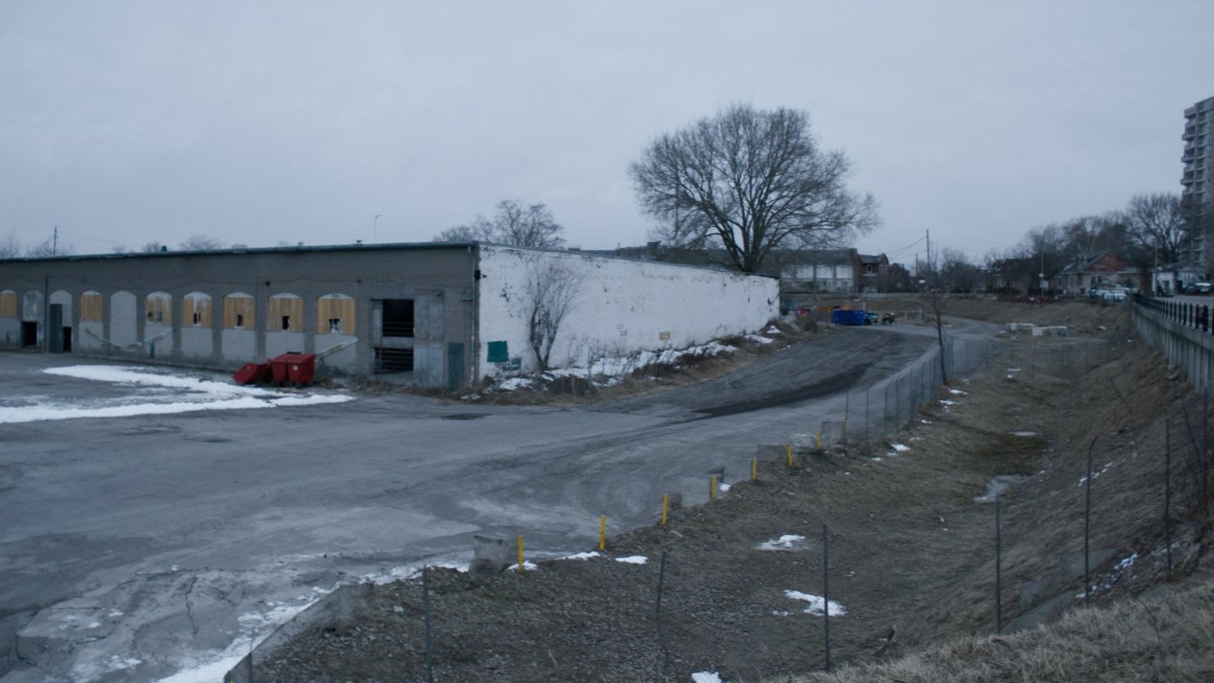 Former industrial site beside Lake Shore Boulevard with condo towers behind (illustrative)