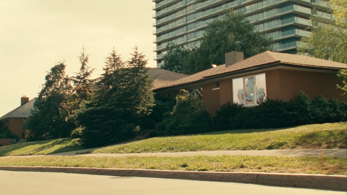 Detached house in front of a condo tower in the GTA (illustrative)