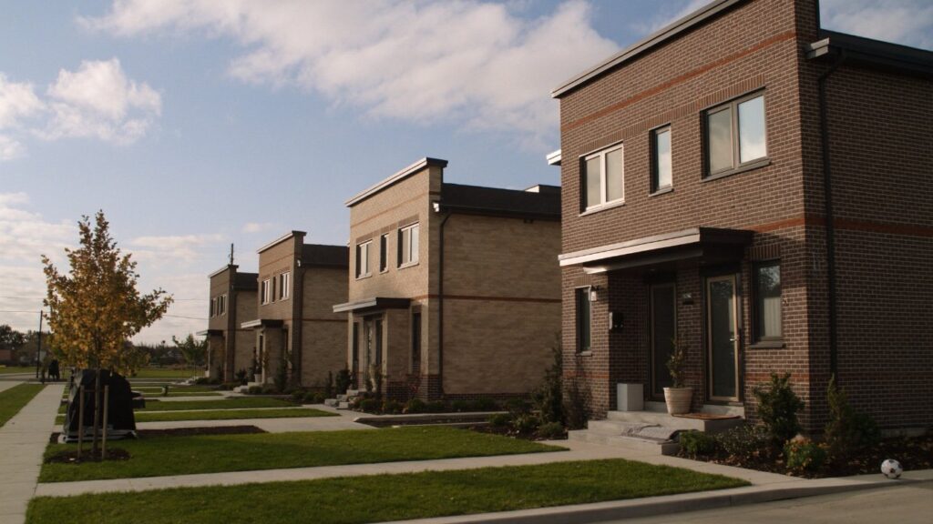 A row of new stacked townhomes on a quiet residential street in the Greater Toronto Area (illustrative)