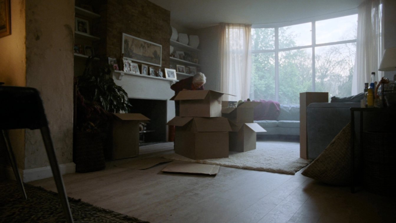 Packing belongings while downsizing from a family home (illustrative)