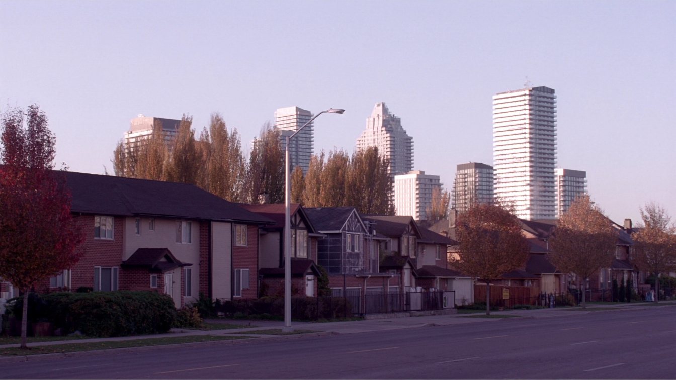 Mid-rise condominium buildings and a row of freehold townhouses on a tree-lined street in Mississauga (illustrative)