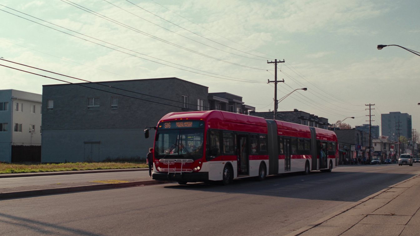 Bus stop on a wide avenue in west Toronto (illustrative)