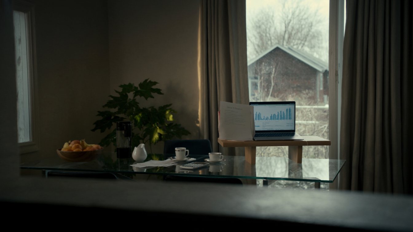 Couple reviewing mortgage affordability numbers at a kitchen table (illustrative)