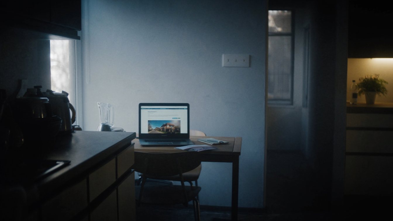 Researching a home builder on a laptop (illustrative)