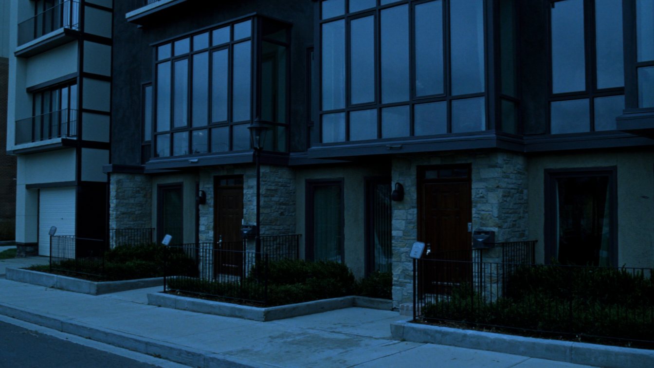 Townhouse units at the base of a waterfront condo tower (illustrative)