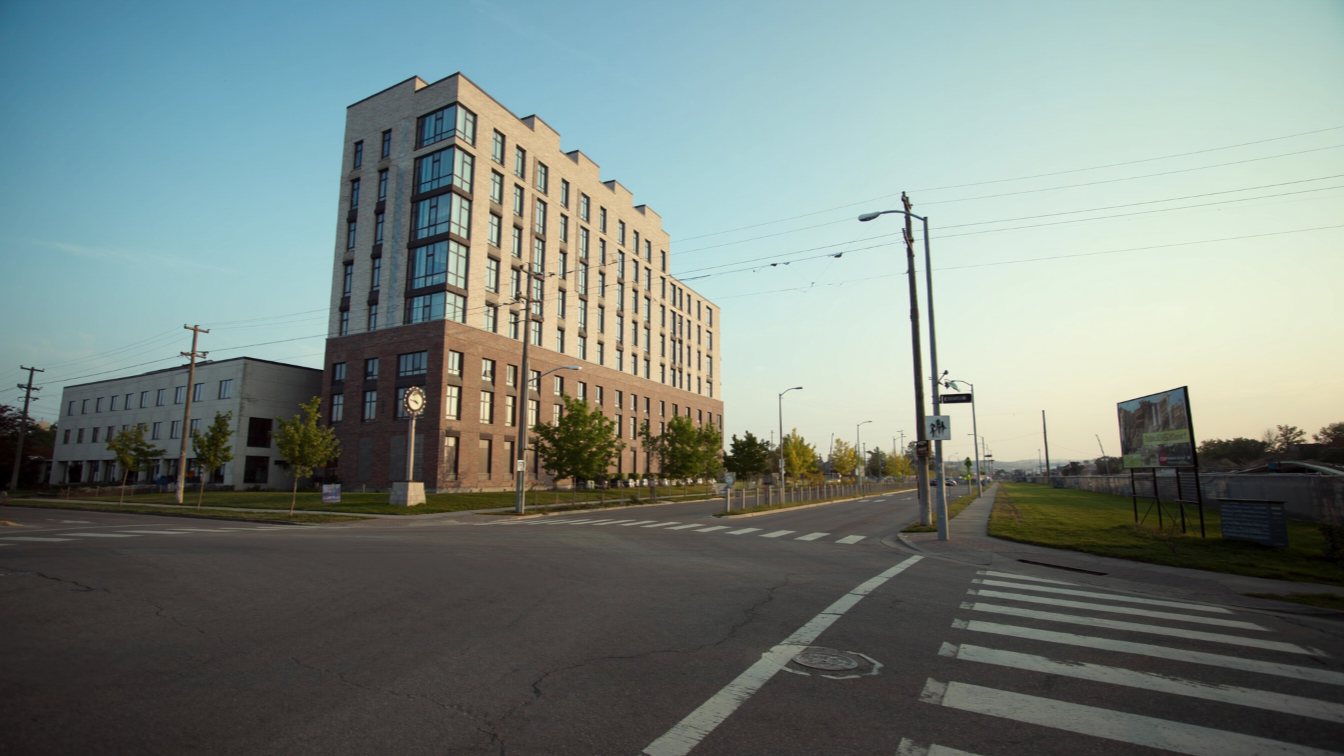 Modern mid-rise condo with ground-floor retail on The Queensway (illustrative)