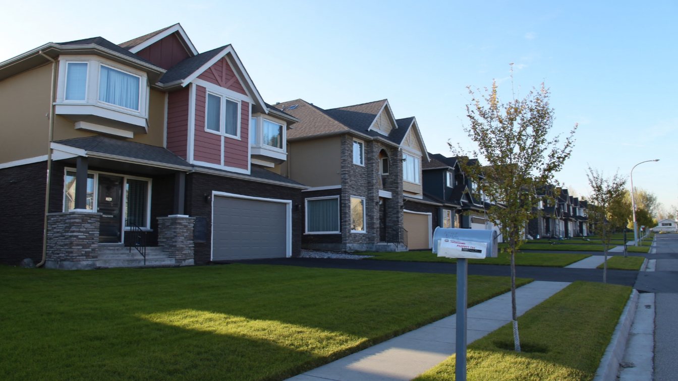 Family homes on an Ontario street with mail in the mailbox (illustrative)