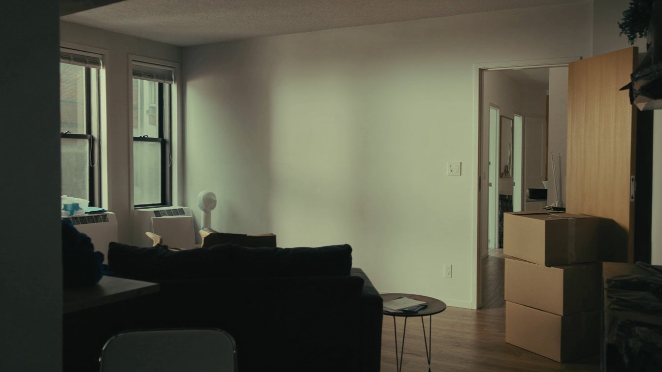 Rented apartment with moving boxes and a notice envelope (illustrative)