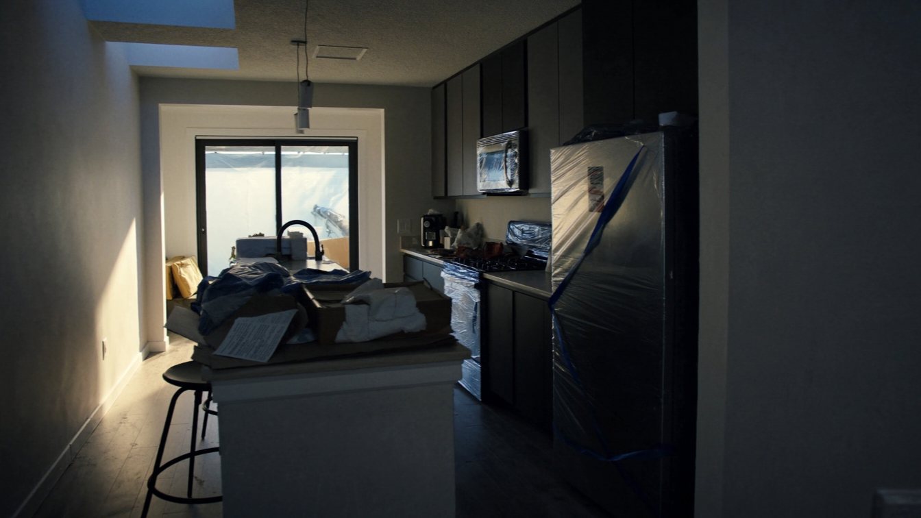 New-build condo kitchen with rebate forms on the island (illustrative)