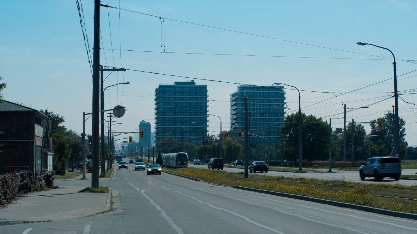 Mid-rise condo towers beside a light rail line on Eglinton Avenue West (illustrative)