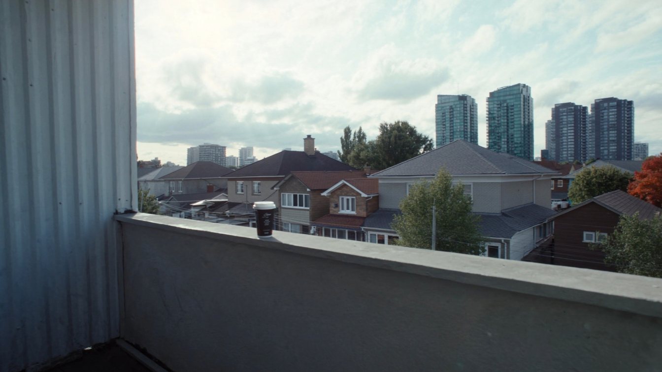 Apartment balcony view over Etobicoke houses and condos (illustrative)