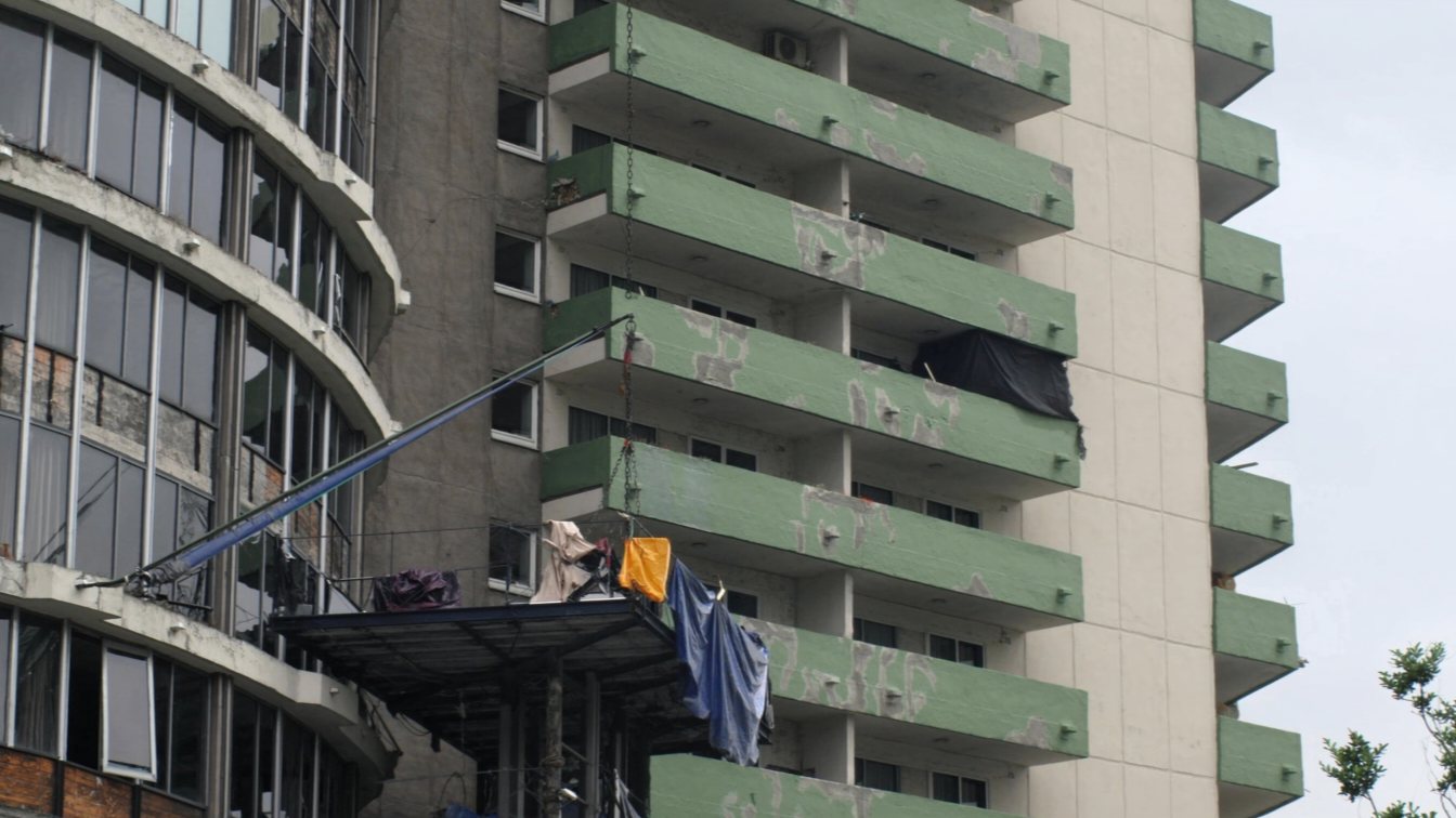 Condo tower with balcony repairs under scaffolding (illustrative)