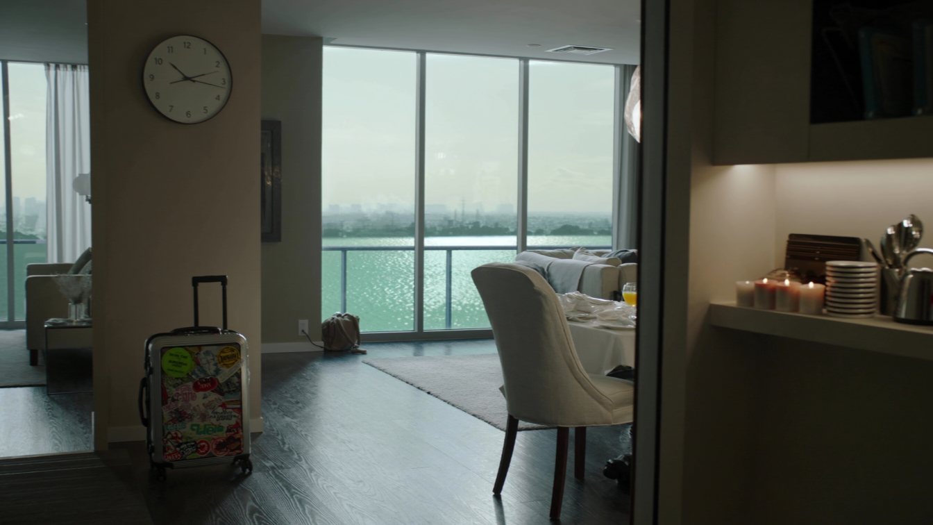 Suitcase inside a condo suite with a lake view (illustrative)