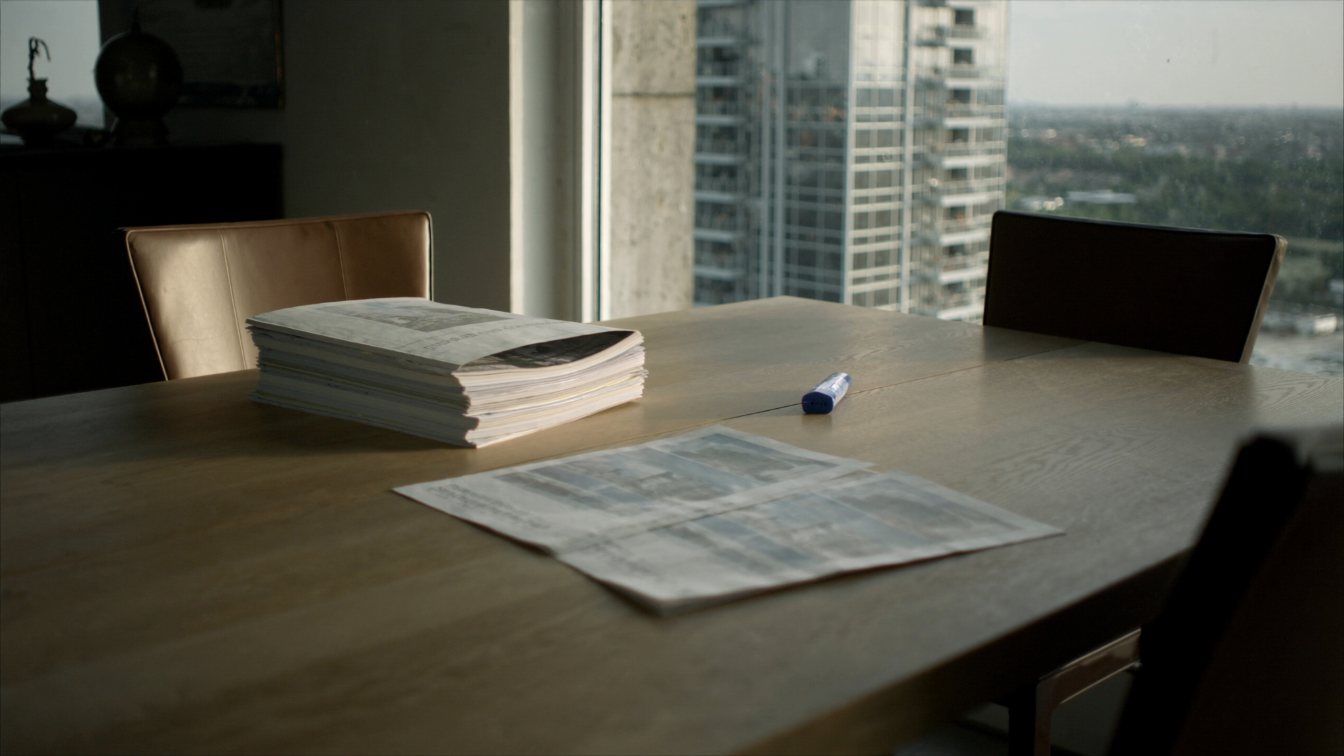 Condo status certificate documents on a table with a tower in the window (illustrative)