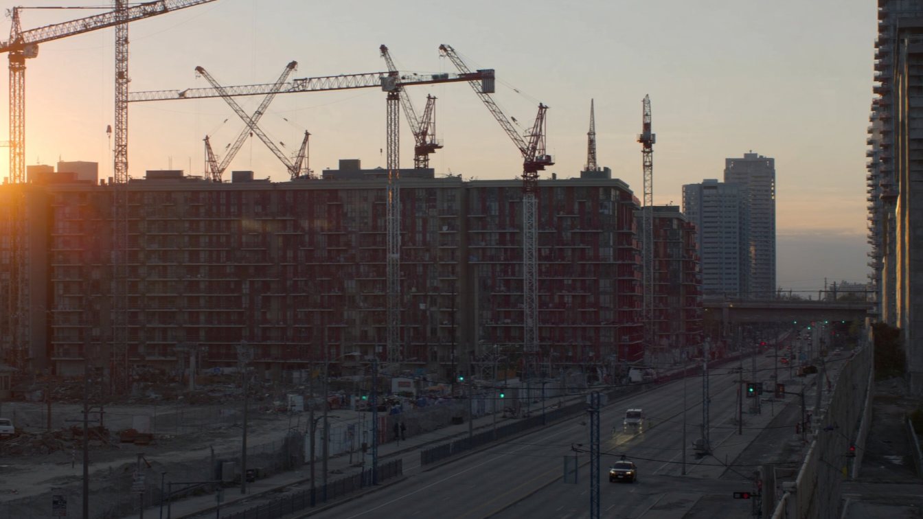 Cranes over new residential buildings on The Queensway (illustrative)