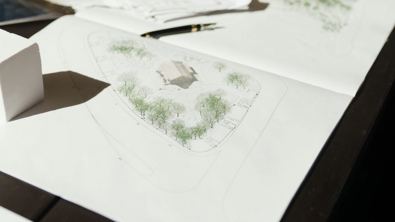 Lot survey drawing with a pen and a house model (illustrative)