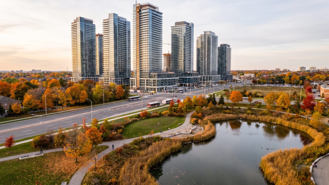 New high-rise condo towers beside a park and pond in a growing suburban downtown (illustrative)