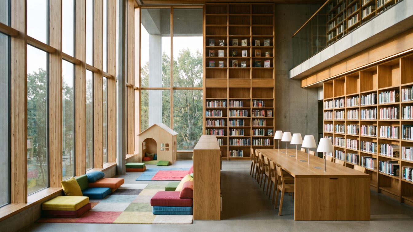 Bright modern library interior with wooden shelves, tall windows and a children's reading corner (illustrative)